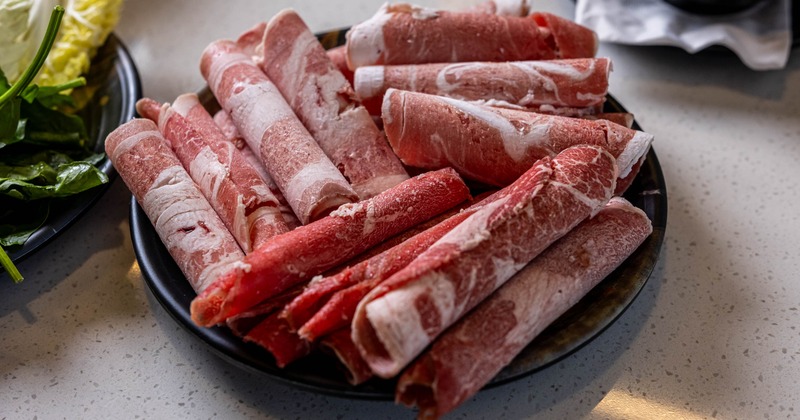 Plate of sliced, raw beef brisket