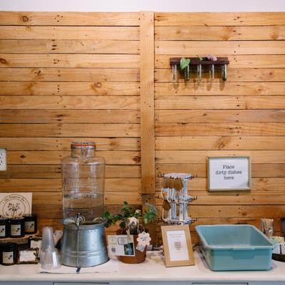 Table with water dispenser and utility box for dirty dishes.