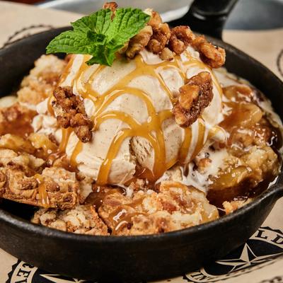 Hot Apple Pie Skillet, served with caramel sauce, and cinnamon ice cream.