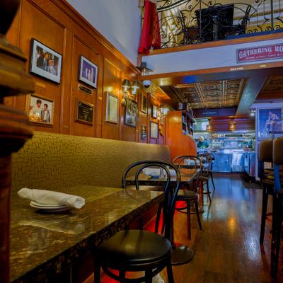 A cozy, dimly lit restaurant interior with wooden wall panels.