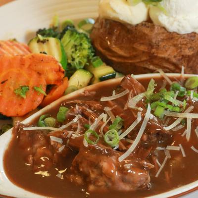 Pot roast beef, served with veggies and baked potato