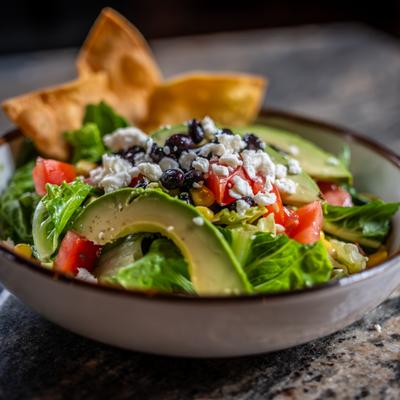 Southwest Salad bowl sits on a marble surface.