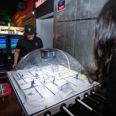 A couple of guests playing bubble dome hockey.