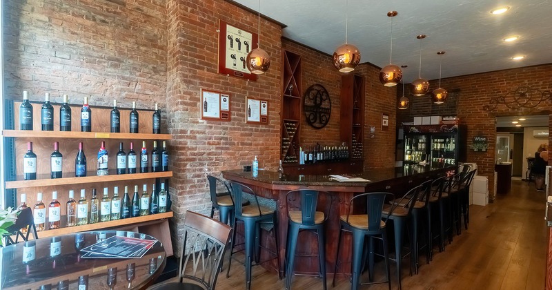 Interior, a bar with wine bottles on the wall