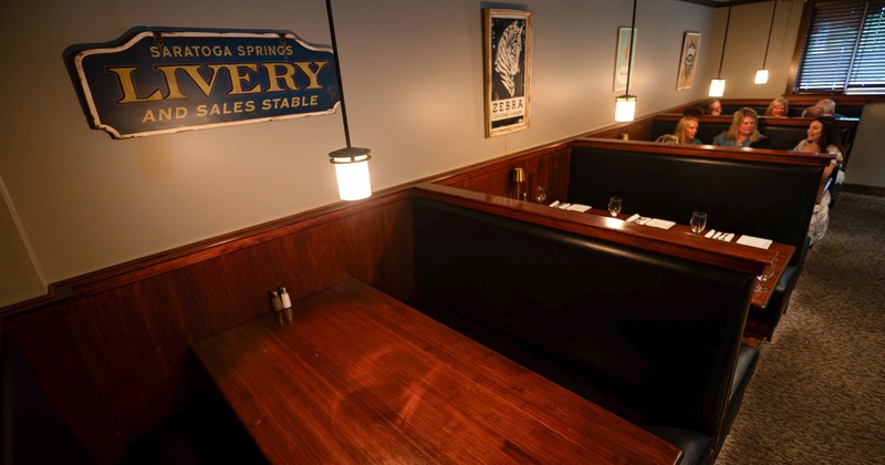 Cozy restaurant interior with wooden booths and warm lighting