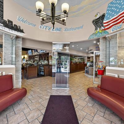 Entrance area featuring a mural of a cityscape and an American eagle with a flag.