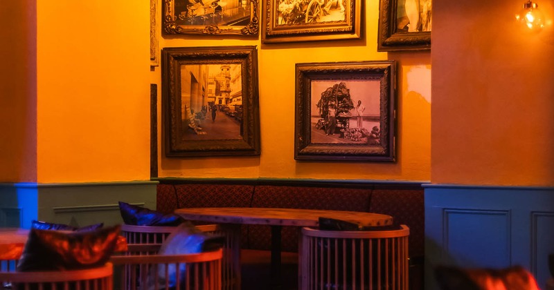 Interior, tables and chairs with pictures on the wall