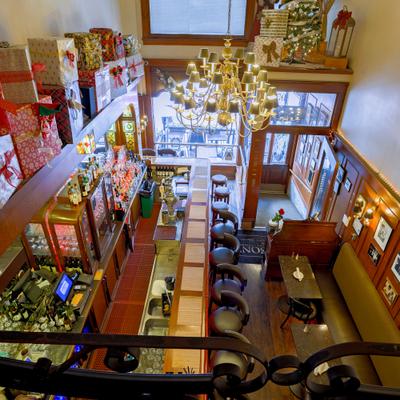 Restaurant interior with a bar, tables, and Christmas decor.