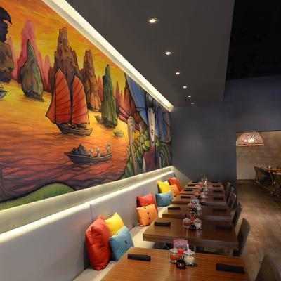 Banquette seating and tables next to a large colorful wall mural.