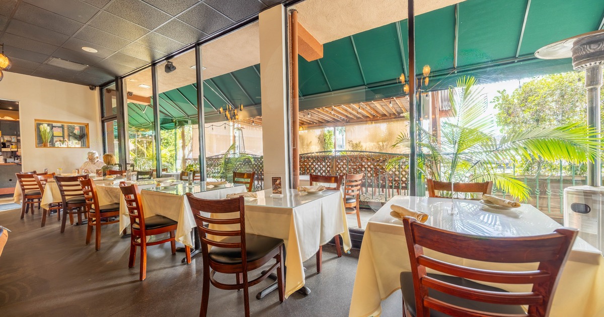 Interior, warm dining area by the large windowpanes