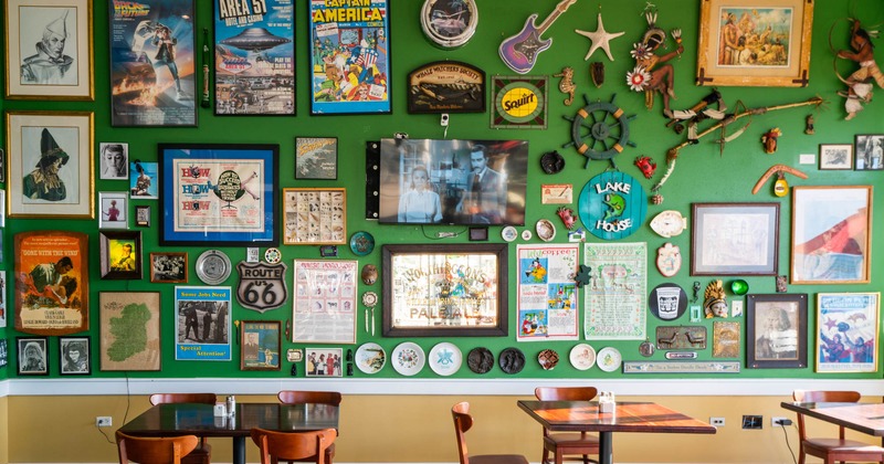 Tables and chairs by decorated photo wall