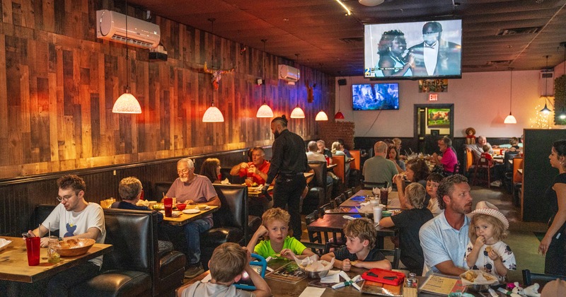 Interior space, dining area full of guests enjoying their food and drinks
