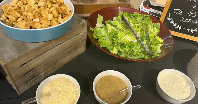 Self-service Caesar salad bar featuring the essential components of the dish