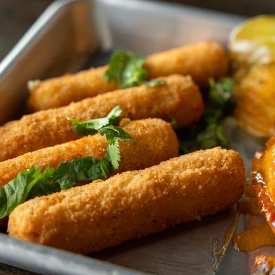 Mozzarella Sticks served alongside wings, close-up.