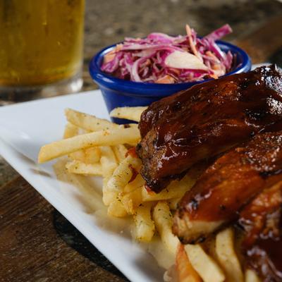 BBQ ribs served over fries with house slaw.