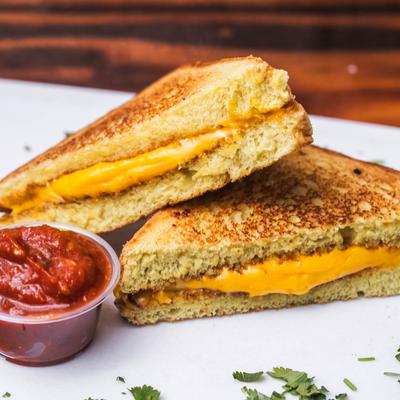 The Classic Grilled Cheese Sandwich with a dipping sauce.