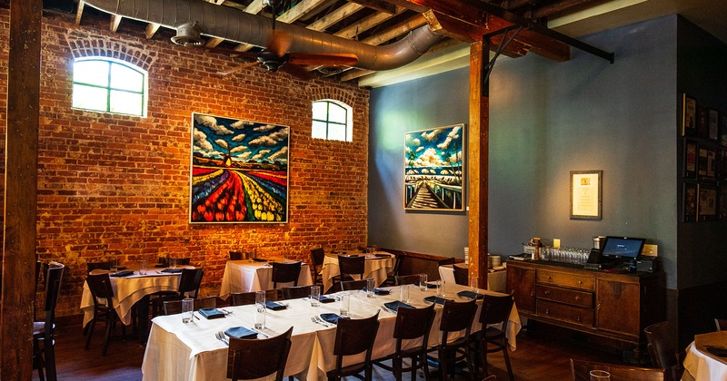 Restaurant interior, set tables, wall artwork