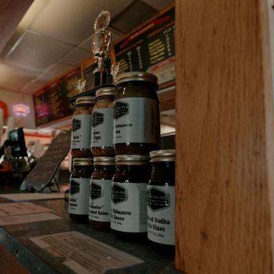 Various jars of sauces and glazes, placed on the counter.