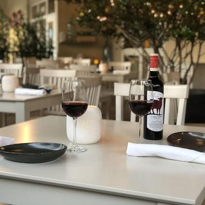 Exterior, seating area,  table setting with red wine