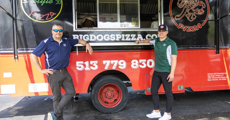 Owners standing by Big Dogs Pizza food truck