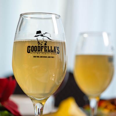 Sparkling drink served in stemmed, branded glass.