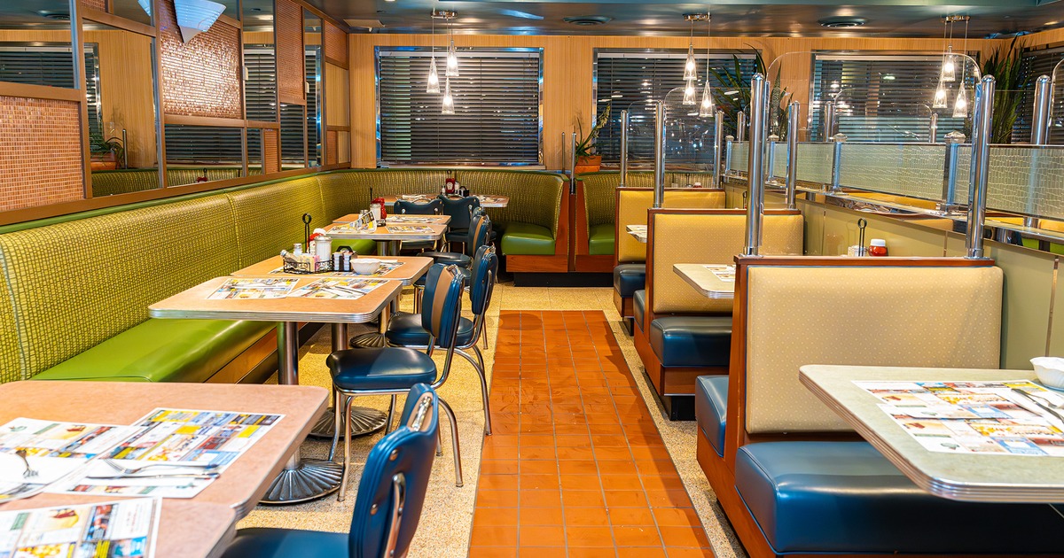 Cozy interior dining area, tables and upholstered seats and dining booths