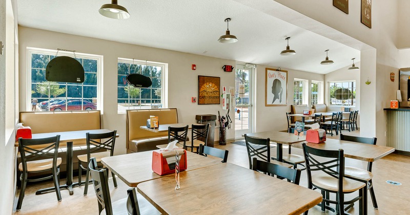 Interior dining area, tables for four people ready for guests