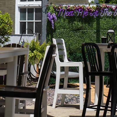 High-top patio tables with black and white chairs.