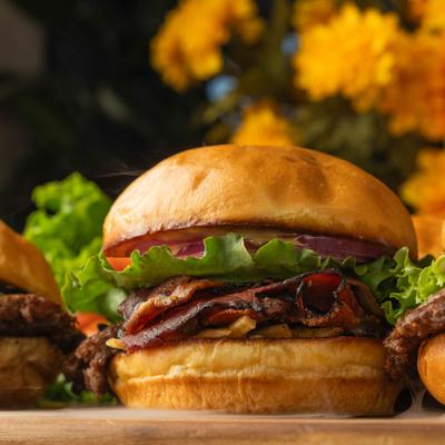 Wooden board with variety of burgers, close-up.