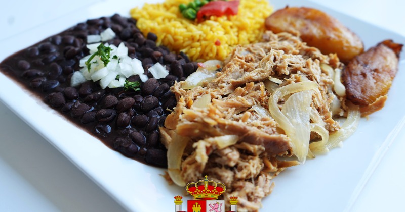 Slow roasted pork with onions, served with rice, black beans, and plantains