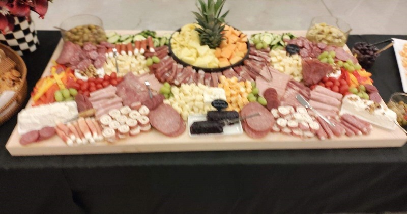 Charcuterie board with meats, cheeses, fruits and crackers