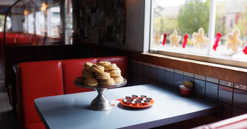 A table by the window with served food