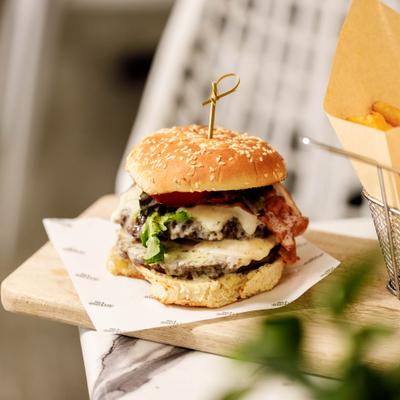 Meat Lover's Burger with two patties, cheese, bacon and a side of fries.