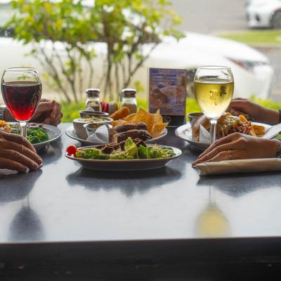 Diner table with food and wine.