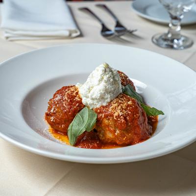 Meatballs in tomato sauce, with ricotta cheese and basil.