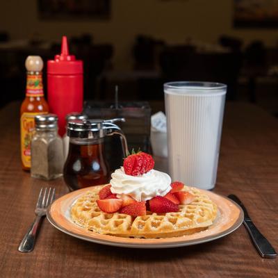 Waffle with strawberries and cream.
