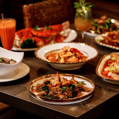 Assortment of dishes served on the table alongside drinks.