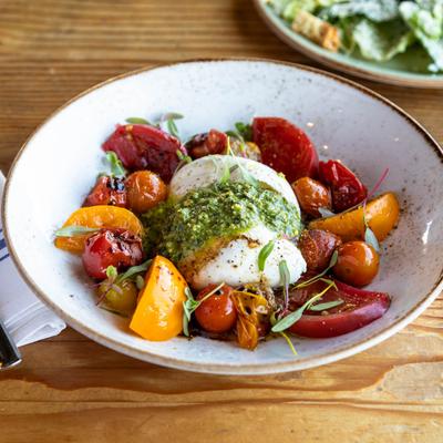 Burrata with heirloom tomatoes and pesto.