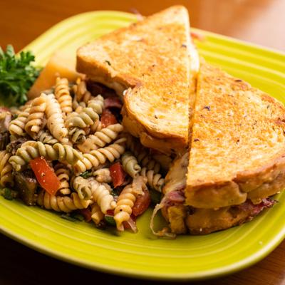 Sliced Corned Beef Sandwich with Pasta Salad.