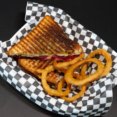 Grilled Bombay Sandwich served with onion rings.