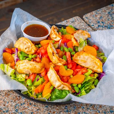 Pot sticker salad with Asian dressing.