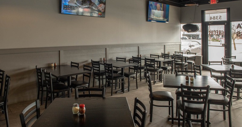 Interior, chairs and tables, TV's on the wall