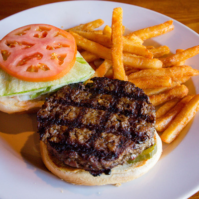 Burger with tomato, lettuce and fries on the side