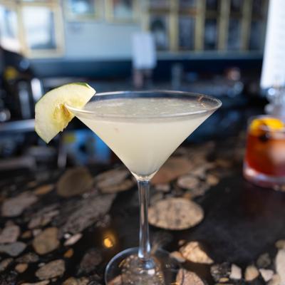 Cool Cucumber Martini garnished with a slice of cucamber on a rim.