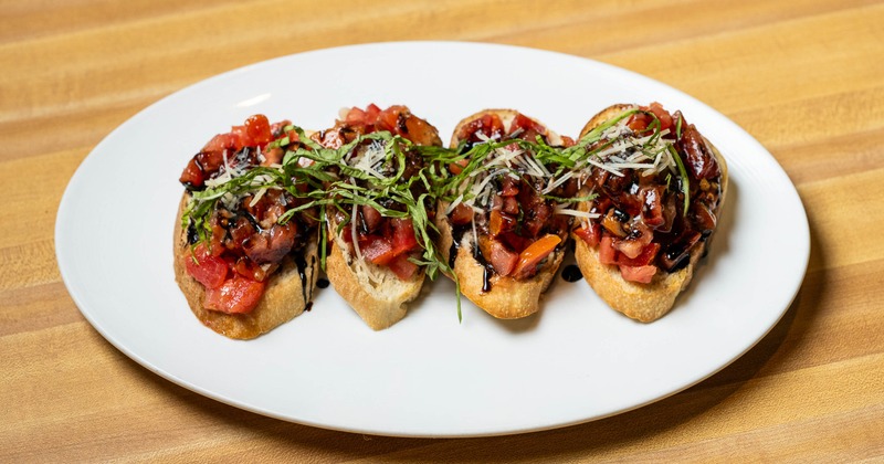 Bruschetta plate served on a wooden table