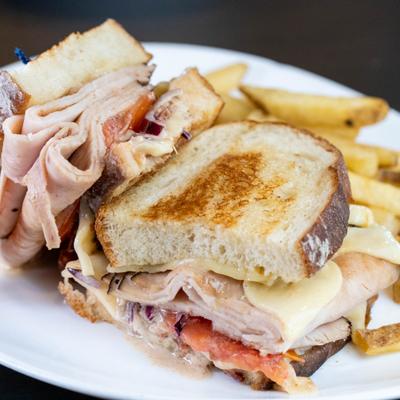 Honey turkey sandwich served with french fries.