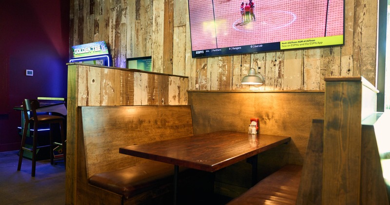 Interior, dining area, closeup on a seating booth with wooden benches and table
