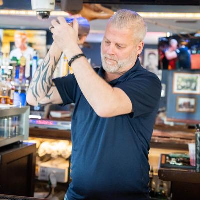 A bartender shaking drink.