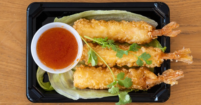 Shrimp tempura served with a side of dipping sauce