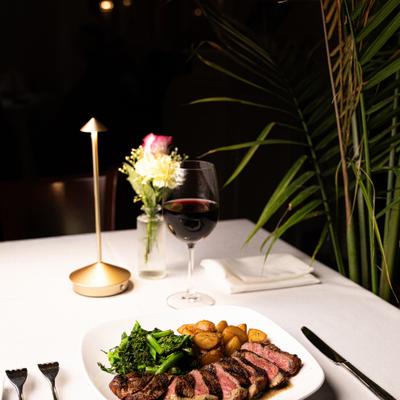 New York Strip Loin with roasted fingerling potatoes, broccoli rabe and a glass of wine.